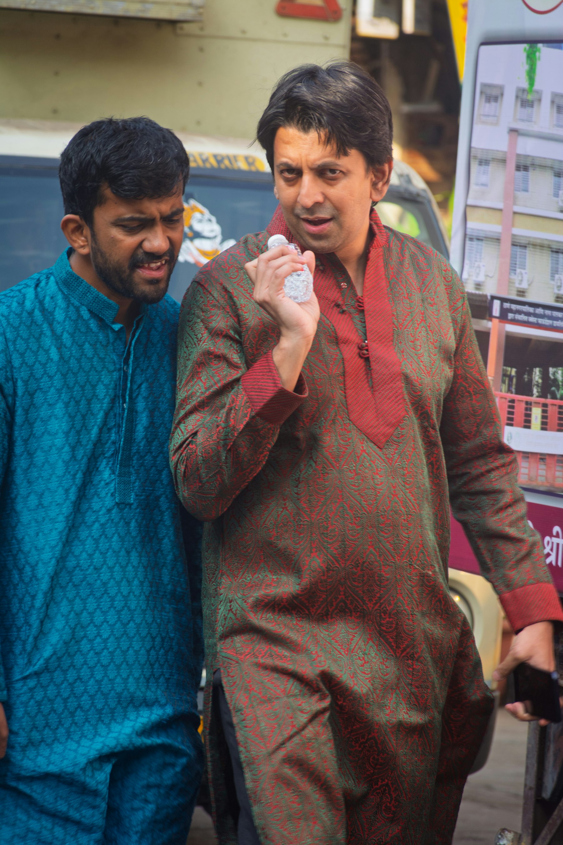 Two men in kurtas, walking